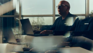 A photographic portrait of Steve Gascoigne from Siemens, sitting at his desk, with a blur effect